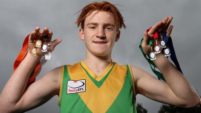 Bayswater’s Ben White with his eight consecutive Eastern Football League best-and-fairest awards. Picture: Hamish Blair