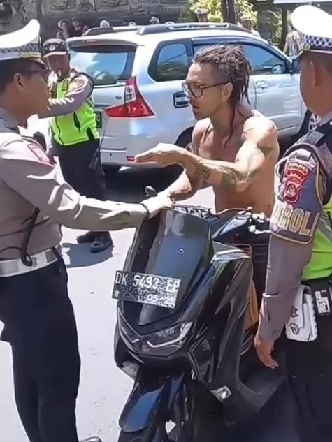 A tourist was pulled over for not wearing a helmet.