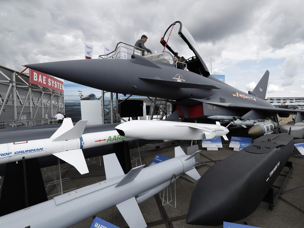 A man sits in the cockpit of a Eurofighter Typhoon aircraft at the Farnborough Airshow. The variety of missiles it can carry are on display. Picture: AFP