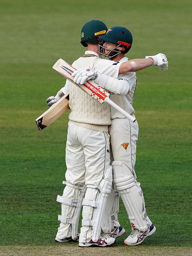 Tigers batsmen Jordan Silk (left) and Charlie Wakim celebrate after Silk hit the winning runs on day 3 of the Marsh Sheffield Shield cricket match between the Tasmanian Tigers and the NSW Blues at Blundstone Arena in Hobart, Sunday, March 8, 2020. (AAP Image/Dave Hunt)