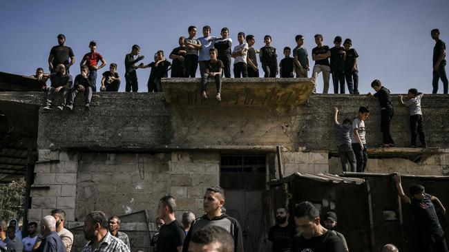 Palestinians watch the funeral of several men who were killed during an overnight raid by the Israeli army into the Jenin refugee camp. Picture: AFP