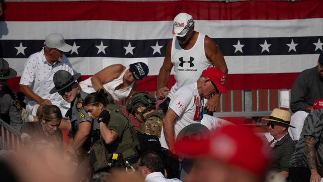 Audience members duck in the crowd during a shooting attempt at a campaign rally for Republican presidential candidate, former U.S. President Donald Trump at Butler Farm Show Inc. on July 13, 2024 in Butler, Pennsylvania. Photo: Jeff Swensen/Getty Images/AFP