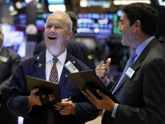 Traders James Riley and Mark Muller on the floor of the New York Stock Exchange, where share prices have been surging — prompting market rallies around the world.