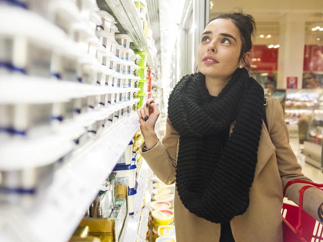 Unit pricing. Shoppers at Coles on Swan Street in Richmond checking unit prices to save on grocery bills. Laura Densely checking the price in the dairy isle.Picture: Eugene Hyland