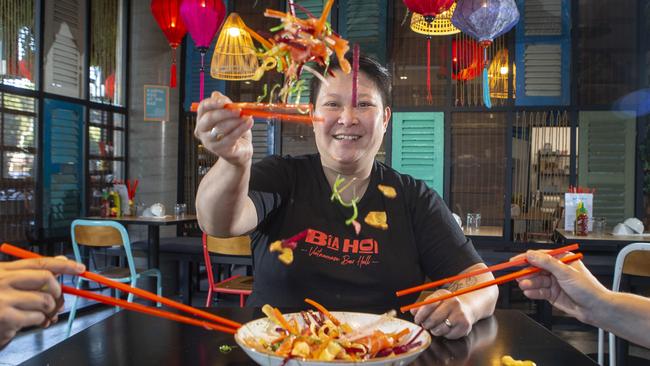 Chef Jerry Mai demonstrates the tradition of tossing the Prosperity Salad. Ms Mai will be serving a Prosperity Salad at her venue Bia Hoi at The Glen until February 9. Picture: Valeriu Campan