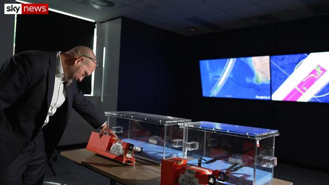 ATSB Chief Commissioner Angus Mitchell with empty boxes that were built to house the flight data recorder and the cockpit voice recorder from the MH370 aircraft when it is found. Picture: Sky News