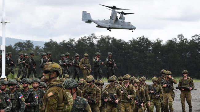 Philippine and Australian soldiers march in formation while a US marines V-22 Osprey hovers above during military exercise Alon, a joint amphibious landing drill held at a naval base in San Antonio, in Zambales province. Picture: Ted Aljibe/AFP