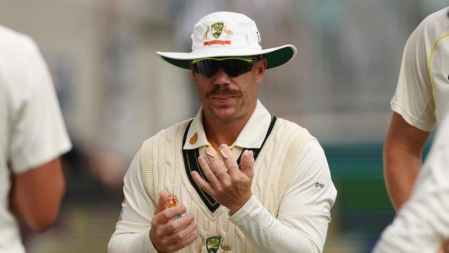 David Warner of Australia blows on his fingers during day two of the First Test match between Australia and the West Indies at Optus Stadium. (Photo by Cameron Spencer/Getty Images)