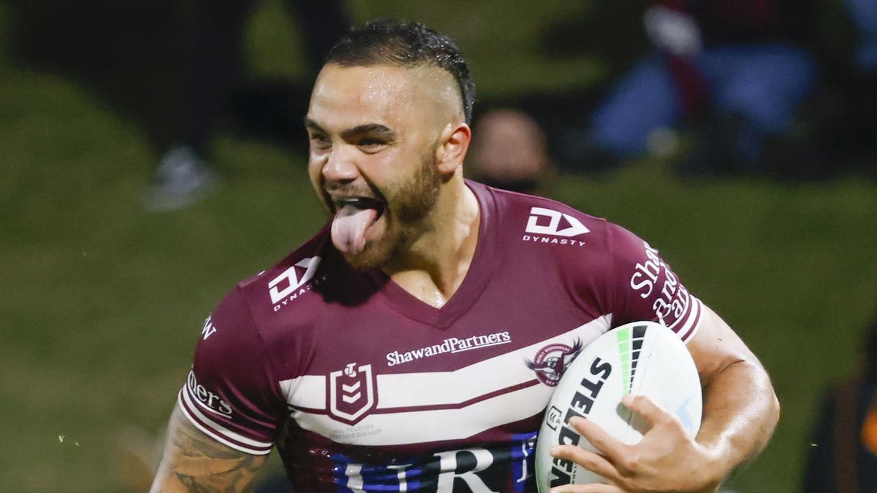 Tolutau Koula of the Sea Eagles is tackled by Cody Walker of the