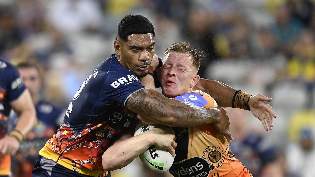 TOWNSVILLE, AUSTRALIA - MAY 24: Alex Seyfarth of the Tigers is tackled by Thomas Mikaele of the Cowboys during the round 12 NRL match between North Queensland Cowboys and Wests Tigers at Qld Country Bank Stadium, on May 24, 2024, in Townsville, Australia. (Photo by Ian Hitchcock/Getty Images)