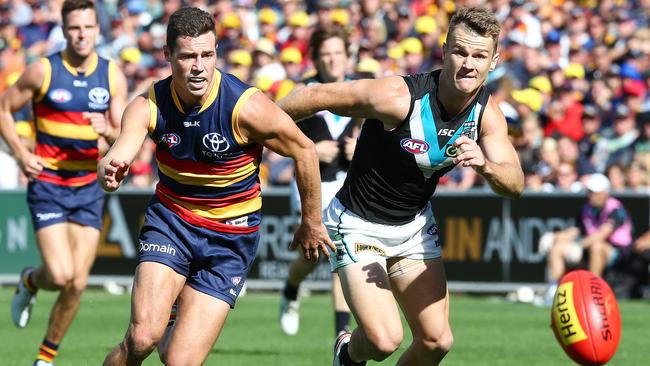 Adelaide Crows’ Luke Brown battles against Port Adelaide’s Robbie Gray.