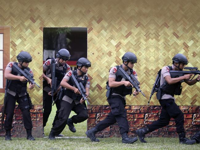 Officers of the Indonesian national police elite unit ‘Mobile Brigade’ take their positions during a drill ahead of Christmas celebration in Medan, North Sumatra, Indonesia on December 21. Picture: AP / Binsar Bakkara