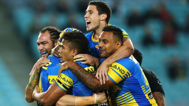 Eels players celebrate a try by Beau Scott.