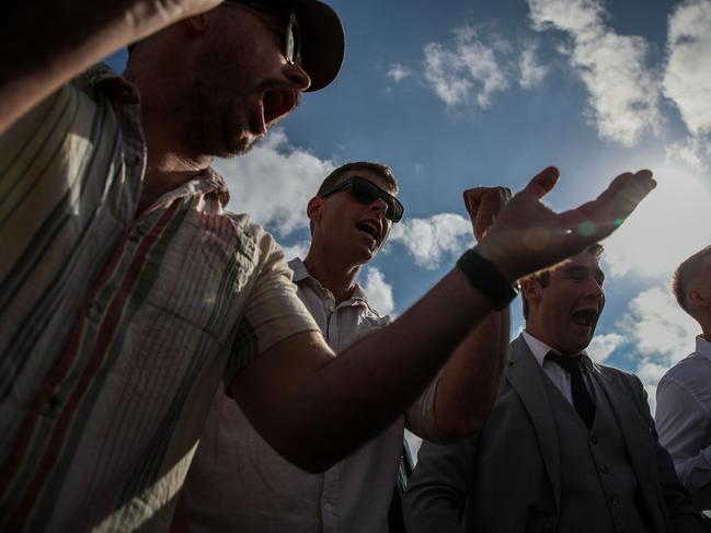 Punters clap and cheer as the coins are tossed. (Photo by Roni Bintang/Getty Images)