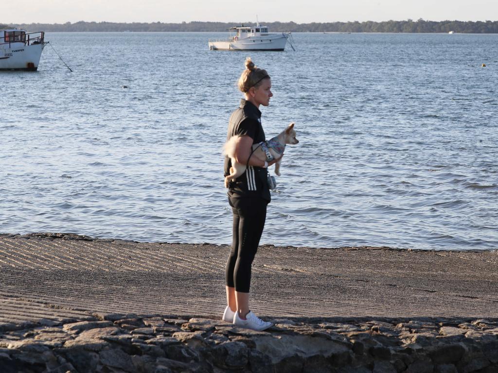 Annaliese Carter with her dog Pebbles near the boat ramp where Amy Schulkins’ submerged vehicle was found. Picture: Annette Dew