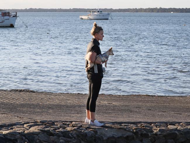 Annaliese Carter with her dog Pebbles near the boat ramp where Amy Schulkins’ submerged vehicle was found. Picture: Annette Dew