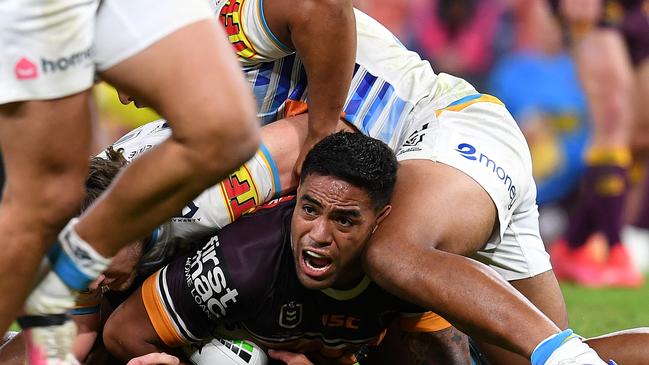 Joe Ofahengaue of the Broncos is tackled (AAP Image/Dan Peled)