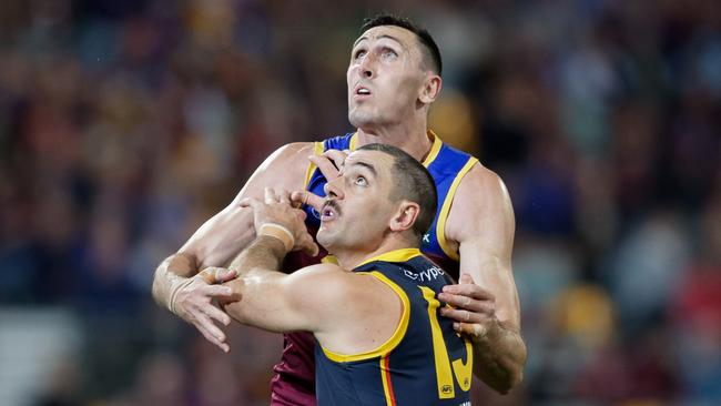 BRISBANE, AUSTRALIA – AUGUST 12: Oscar McInerney of the Lions and Taylor Walker of the Crows in action during the 2023 AFL Round 22 match between the Brisbane Lions and the Adelaide Crows at The Gabba on August 12, 2023 in Brisbane, Australia. (Photo by Russell Freeman/AFL Photos via Getty Images)