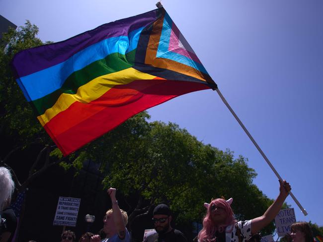 A Progress Pride Flag is held above the crowd of LGBTQ+ activists during the Los Angeles LGBT Center's "Drag March LA: The March on Santa Monica Boulevard", in West Hollywood, California, on Easter Sunday April 9, 2023. - The march comes in response to more than 400 pieces of legislation targeting the LGBTQ+ community that government officials across the United States have proposed or passed in 2023. (Photo by ALLISON DINNER / AFP)