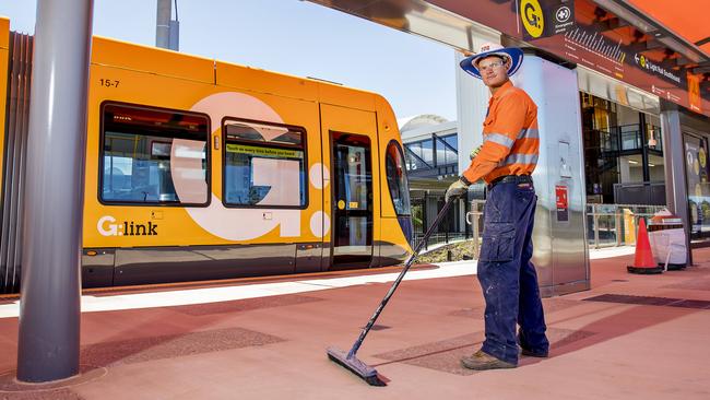 Tim Allen putting the final touches on the Helensvale tram station before the launch. Picture: Jerad Williams