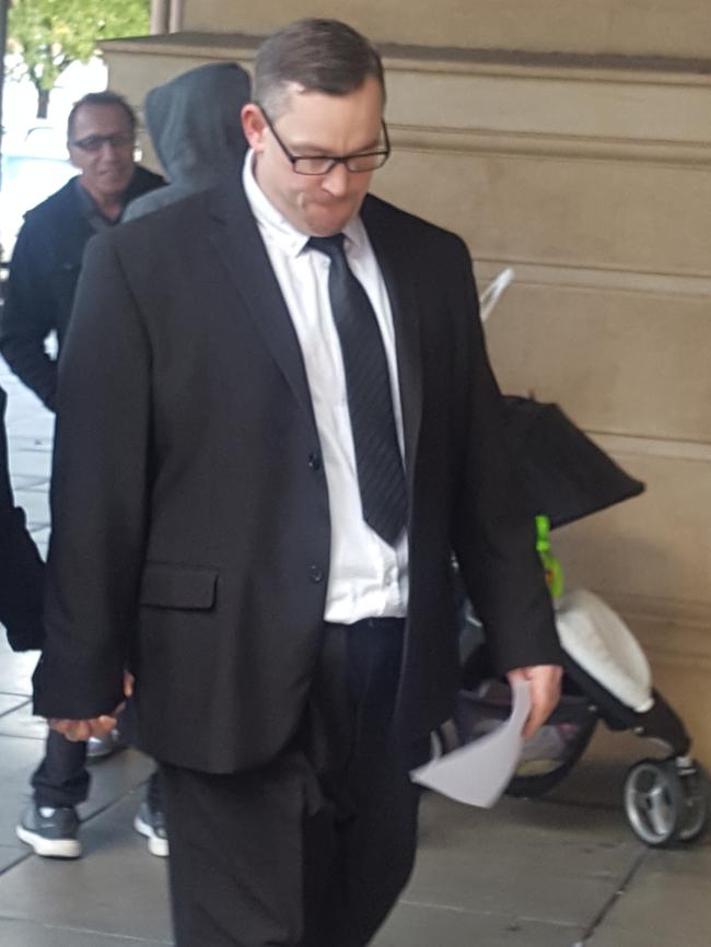 Jason Fraser who was a bikie 'associate' of the Nomads outlaw motorcycle gang leaves the Supreme Court with a supporter after receiving a suspended sentence for his part in a home invasion.