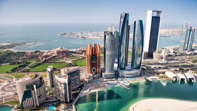 Part of Abu Dhabi, UAE with tall buildings and surrounding area viewed from the helicopter. Many details are visible in the image.