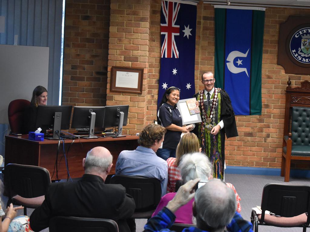 Malivan Powley receiving her citizenship from mayor Isaac Smith