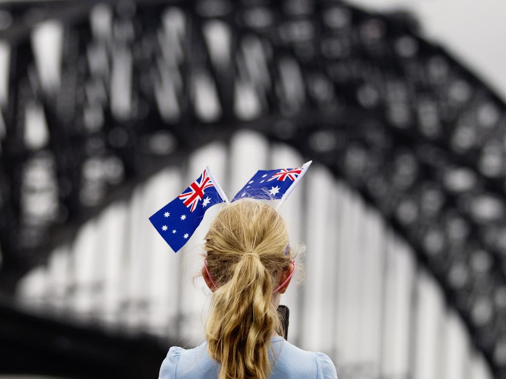 Young girl dwith hair decorated with flags enjoys Australia Day festivities at Circular in Sydney. Picture: Jenny Evans