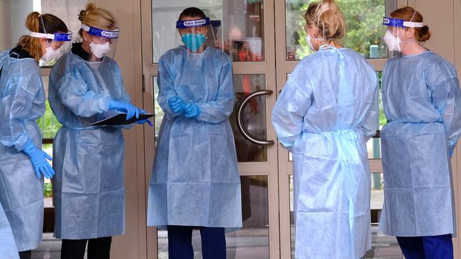 Nurses arrive to check on tenants of the Southbank apartment complex. Picture: NCA NewsWire/Luis Ascui