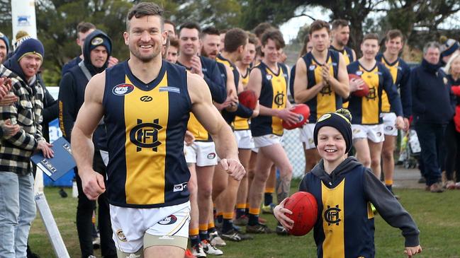 Daniel Keenan runs out alongside his son for his 400th game. Picture: Hamish Blair