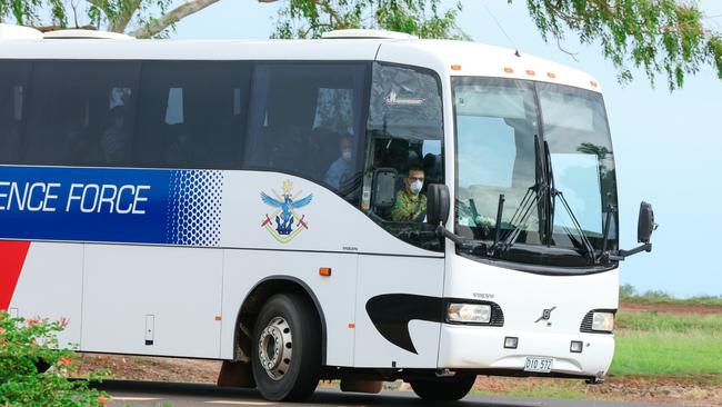 A bus carrying returning Australians en route to 14 days quarantine at a former mining camp. Picture: Glenn Campbell