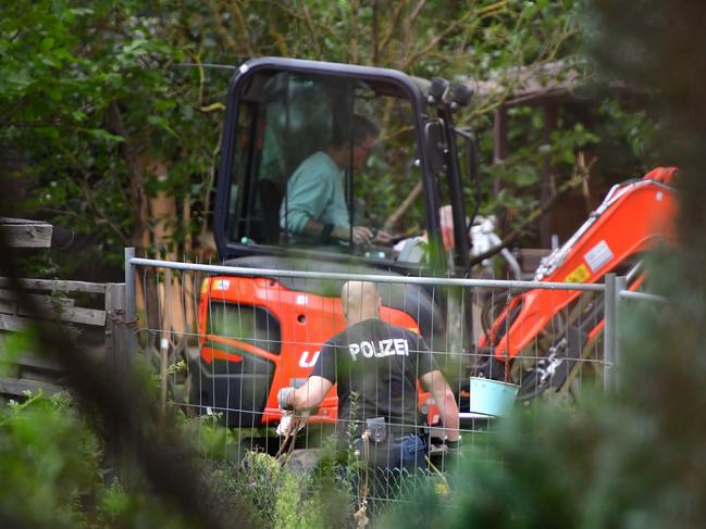 Police officers use a digger at an allotment garden near Hannover in an operation linked to Madeleine McCann. Picture: Getty Images