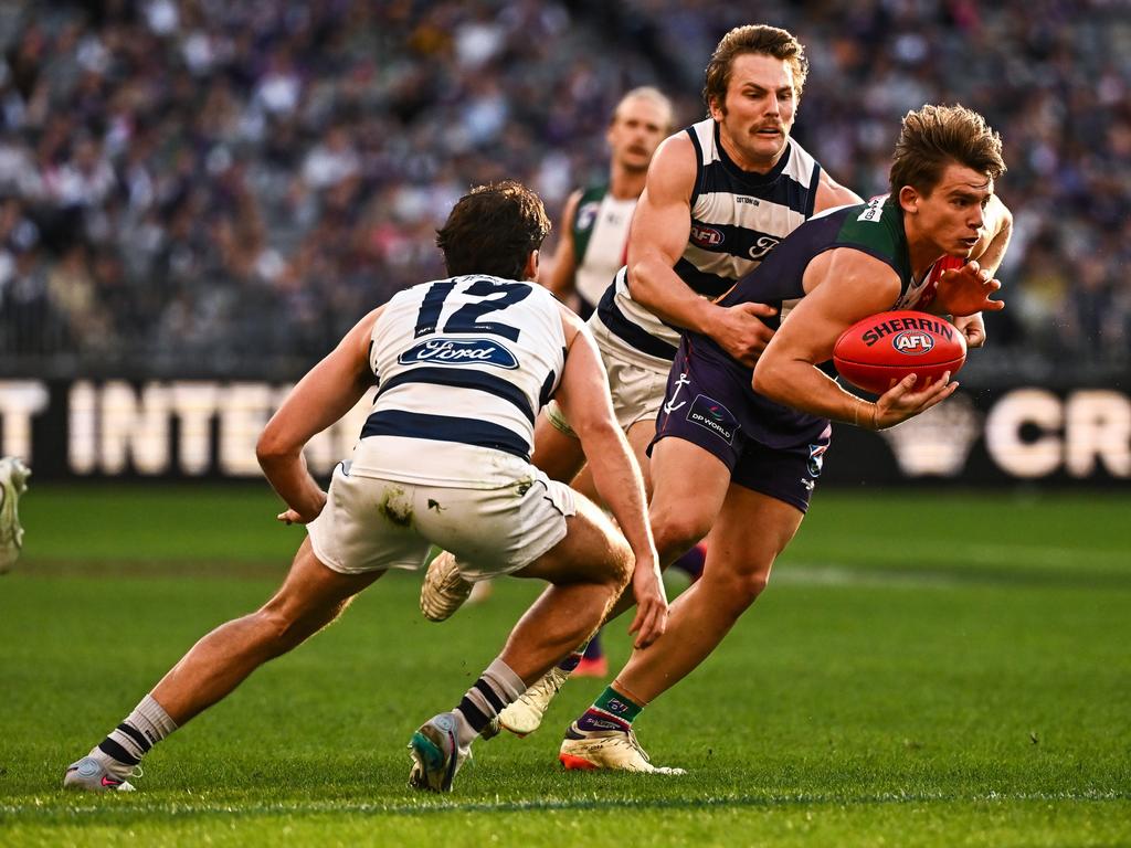 Caleb Serong powers past Tom Atkins and Jack Bowes. Picture: Daniel Carson/AFL Photos