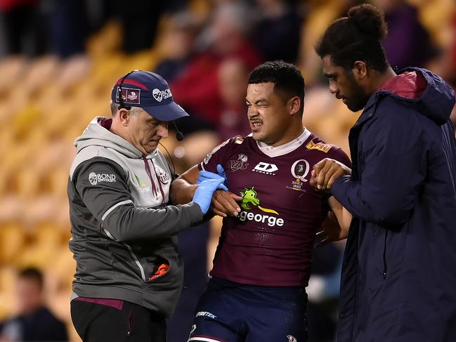 Injured Reds centre Hunter Paisami is taken from the field in Queensland’s win over the Rebels. Picture: Albert Perez/Getty Images