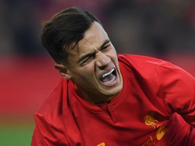 Liverpool's Brazilian midfielder Philippe Coutinho holds his foot as he lies on the pitch injured during the English Premier League football match between Liverpool and Sunderland at Anfield in Liverpool, north west England on November 26, 2016. / AFP PHOTO / Paul ELLIS / RESTRICTED TO EDITORIAL USE. No use with unauthorized audio, video, data, fixture lists, club/league logos or 'live' services. Online in-match use limited to 75 images, no video emulation. No use in betting, games or single club/league/player publications. /