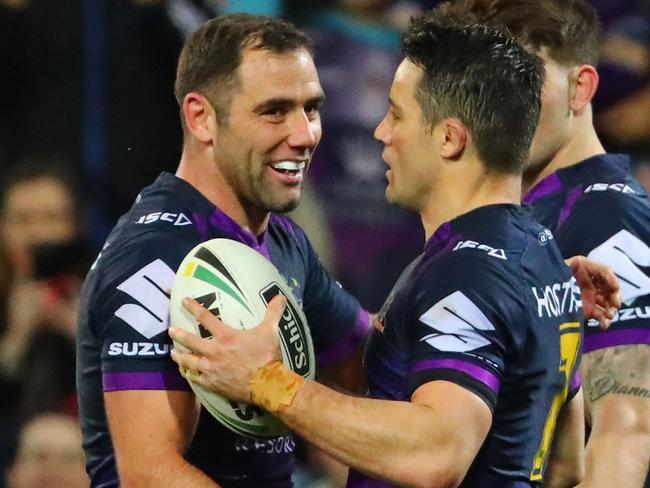 Cooper Cronk is congratulated by Cameron Smith after scoring a try.