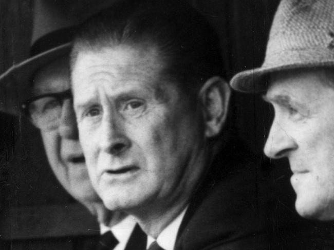 1965? Melbourne coach Norm Smith watches the game with Melbourne committeemen 'Checker' Hughes (left) and Harry Long. Frank Hughes. Picture: Photo File