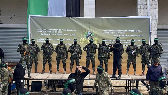 Hamas fighters gather at a square in Gaza City before being due to hand over four Israeli women hostages to the Red Cross in Gaza City on Saturday. Israeli helicopters were expected to collect the hostages. Picture: AFP