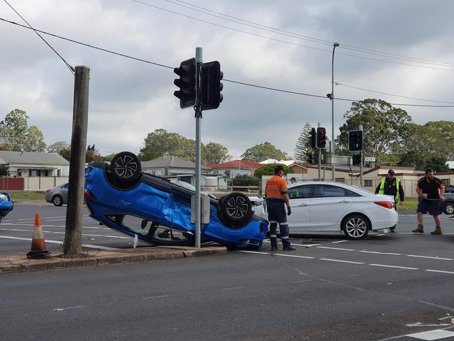 Car flips onto roof after crash at busy intersection