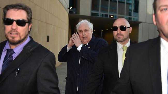 Clive Palmer, flanked by minders, leaves the Federal Court in Brisbane. Picture: Dan Peled