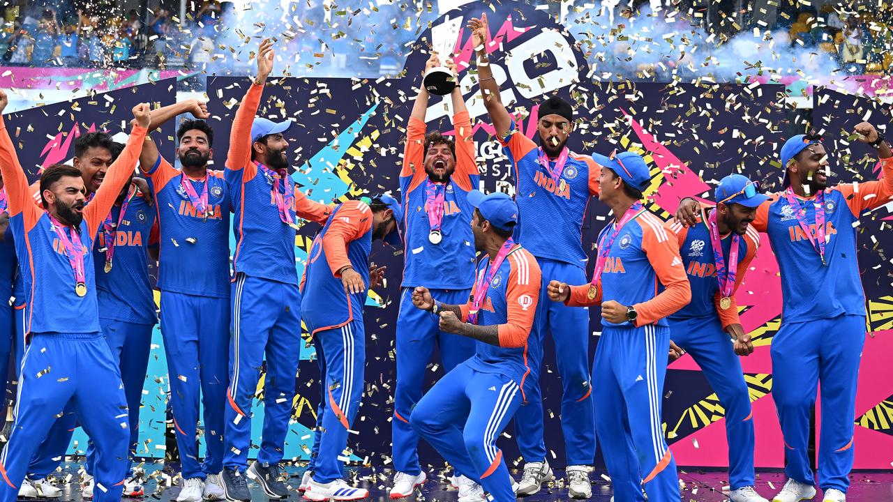 Kuldeep Yadav of India lifts the ICC Men's T20 World Cup trophy. Photo by Alex Davidson-ICC/ICC via Getty Images