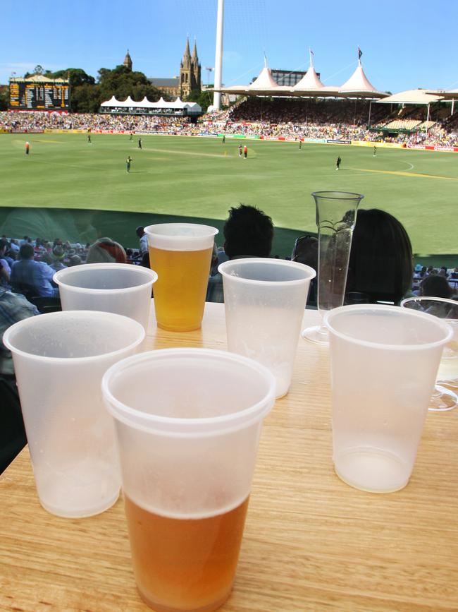 Plastic beer cups empty, full and half full inside the Adelaide Oval's Members Bar.