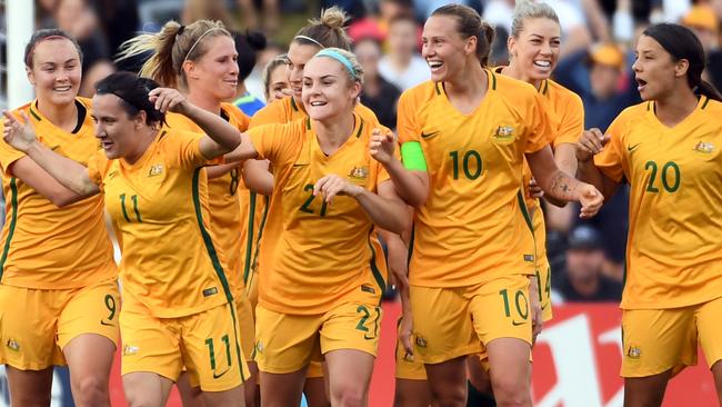 Australia's players celebrate their first goal against Brazil during their friendly women's football match in Sydney on September 16, 2017. / AFP PHOTO / SAEED KHAN / -- IMAGE RESTRICTED TO EDITORIAL USE — STRICTLY NO COMMERCIAL USE —