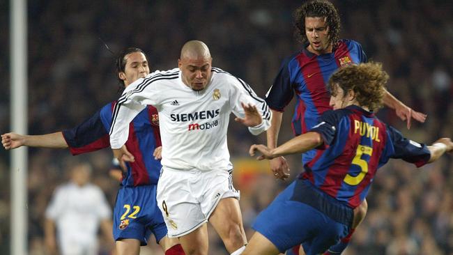 Ronaldo of Real Madrid is challenged by Puyol, Motta and Luis Garcia.