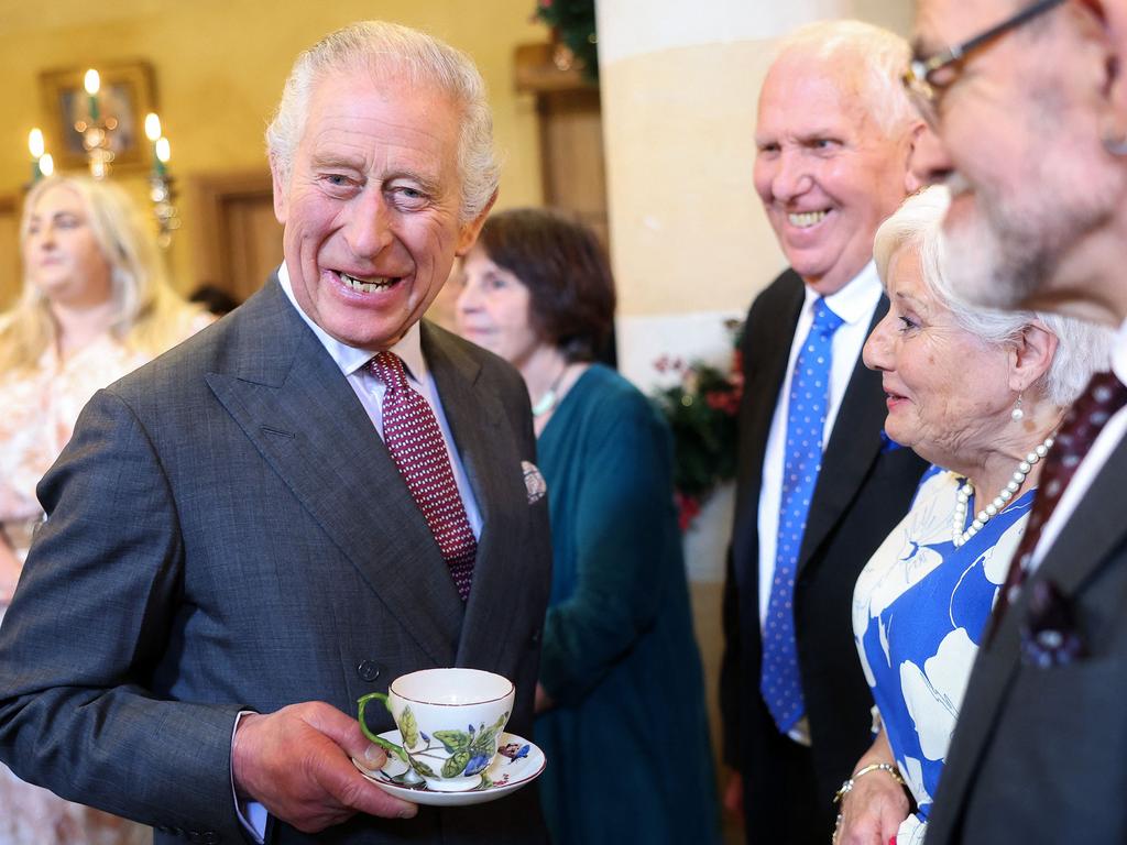 King Charles III reacts while holding a cup and saucer, as he meets with guests during a 75th birthday party for him, hosted by the Prince's Foundation, at Highgrove House. Picture: AFP