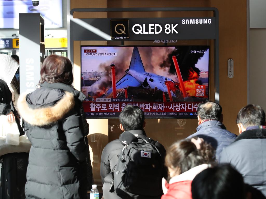 People watch the news regarding the plane crash at Seoul station on December 29, 2024 in Seoul, South Korea. Picture: Chung Sung-Jun/Getty Images