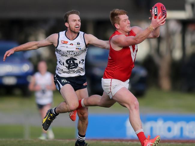 SANFL: North's Mitchell Harvey marks in front of South's Bradley Crabb. South Adelaide v North Adelaide at Noarlunga Oval. 21 July 2018. (AAP Image/Dean Martin)