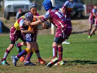 ZONE IN: Roma U12 players work together to tackle a Jandowae player at the Zone 4 Rugby League Carnival in Roma. Picture: Molly Hancock