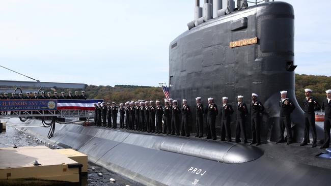 Crew members stand on the topside of the submarine during the commissioning of the USS Illinois, the 13th ship of the Virginia class of submarines in 2016. Picture: REUTERS/Michelle McLoughlin