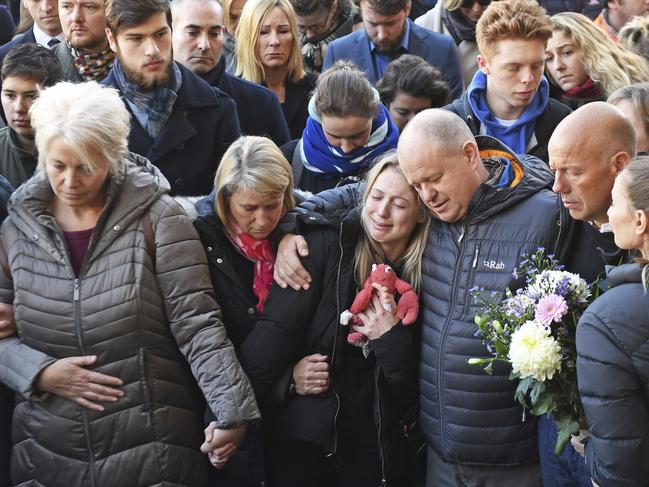 The family of Jack Merritt at a vigil to honour students Saskia Jones and Jack, killed in the attack on London Bridge. Jack’s girlfriend, centre, clutches toy and weeps. Picture: PA via AP